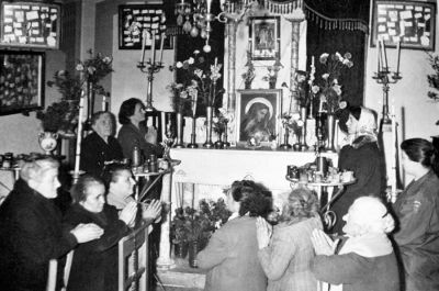 Donne in preghiera davanti all'immagine di Cristo